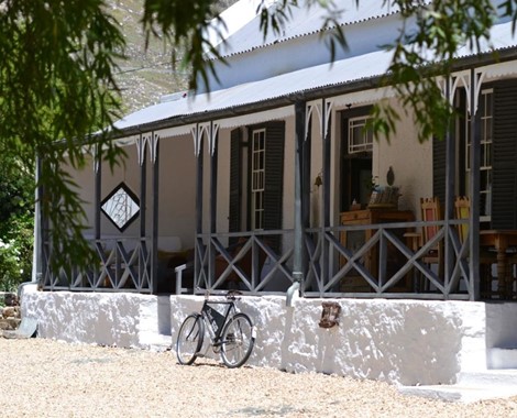 An 1835 Cape Dutch Farmhouse and outbuildings at the edge of the town, infused with great personality